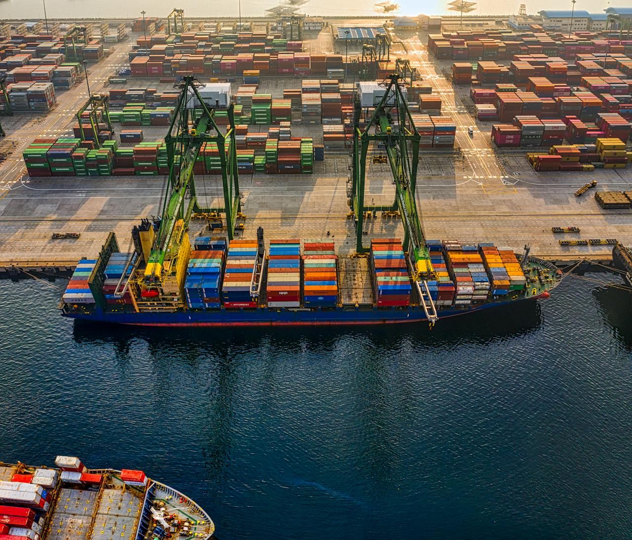 Aerial shot of colorful shipping containers at North Jakarta's bustling port, Indonesia.